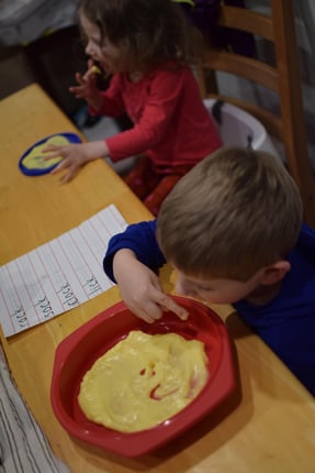 Kid Writing in Pudding